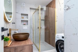 a bathroom with a bowl sink and a shower at Natura Vita Apartment-New Modern Apartment with City View & two Free Parking Spaces-10 min Walk to Trogir Old Town in Trogir +34 photos