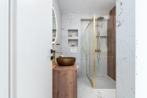 a bathroom with a wooden sink and a shower at Natura Vita Apartment-New Modern Apartment with City View & two Free Parking Spaces-10 min Walk to Trogir Old Town in Trogir +39 photos