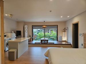 a room with a kitchen and a living room at Stay33 Pet friendly house near Hwangridangil in Gyeongju