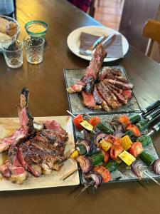 two plates of meat and vegetables on a table at Villa Giordani affittacamere Boscoreale in Piandelagotti +6 photos