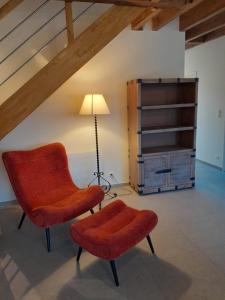 a living room with a chair and a lamp at La gite des 1000 plantes in Courcelles-de-Touraine
