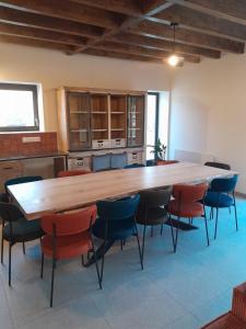 a large kitchen with a large wooden table and chairs at La gite des 1000 plantes in Courcelles-de-Touraine