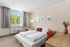 Postel nebo postele na pokoji v ubytování Hotel Schild