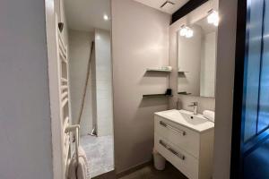 a bathroom with a sink and a mirror at Le Jardinet - With office in the city center! in Castelnau-le-Lez
