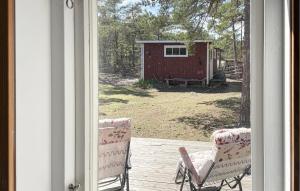 a view of a porch with two chairs and a shed at 3 Bedroom Cozy Home In Tingstäde in Tingstäde +17 photos