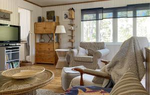 a living room with a couch and chairs and a television at 3 Bedroom Cozy Home In Tingstäde in Tingstäde