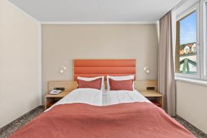 Postel nebo postele na pokoji v ubytování Hotel Schild