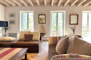 a living room with two couches and a table at Le Magnan - Stone family home in Castries! in Castries