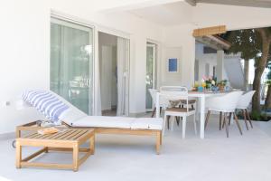a patio with a couch and a table and chairs at Arba apartmani in Barbat na Rabu