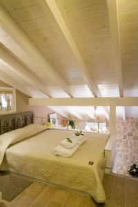 a bedroom with a large bed with towels on it at Village House Lianelia Boutique in Argyrádes