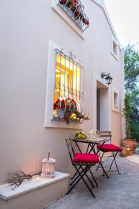 a patio with a table and chairs and a window at Village House Lianelia Boutique in Argyrádes +30 photos