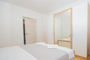 Posteľ alebo postele v izbe v ubytovaní Apartmani Cimerman