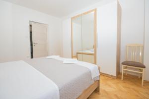 Posteľ alebo postele v izbe v ubytovaní Apartmani Cimerman