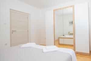 Posteľ alebo postele v izbe v ubytovaní Apartmani Cimerman
