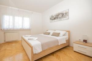 Posteľ alebo postele v izbe v ubytovaní Apartmani Cimerman