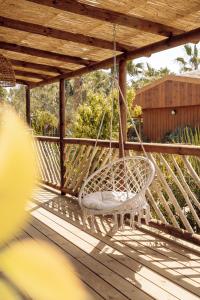a swinging chair on a porch with a wooden deck at Toison D'or in Saint-Tropez