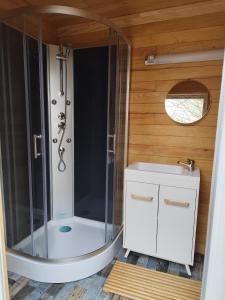 a small bathroom with a shower and a sink at Camping de la Vallée du Doux in Boucieu-Le-Roi