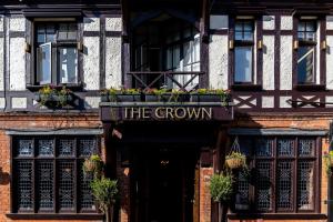 a building with a sign that reads the grown at Crown Hotel in Chertsey