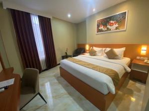 Postel nebo postele na pokoji v ubytování Grand Avira Hotel