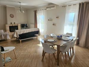 a living room with a table and chairs and a couch at Sylvia's Sweet Home in Kato Korakiana