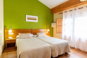 Postel nebo postele na pokoji v ubytování Hotel Rey Don Jaime