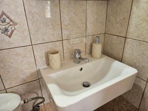 a bathroom with a white sink and a toilet at Sylvia's Sweet Home in Kato Korakiana +75 photos
