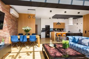 a living room with a blue couch and a table at Apartament Sobieskiego Kutno in Kutno