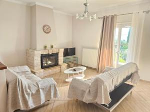 a living room with a couch and a fireplace at Sylvia's Sweet Home in Kato Korakiana
