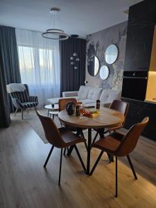 a living room with a table and chairs at Gold Premium Apartment in Suwałki