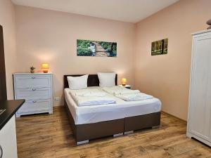 a bedroom with a bed and a dresser at Villa Utpatel Whg 02 in Ahlbeck