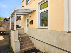 a house with stairs leading up to a door at Villa Utpatel Whg 03 in Ahlbeck