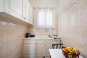 a kitchen with a bowl of fruit on a table at ANESIS I in Livadi +32 photos