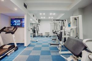 a gym with treadmills and machines in a room at COLORFACTORY SPA Hotel - Czech Leading Hotels in Prague