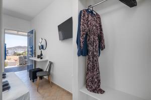 a room with a dress hanging on a wall at ANESIS I in Livadi