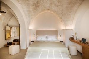 a bedroom with a bed with a stone ceiling at Borgo delle Dimore in Maglie