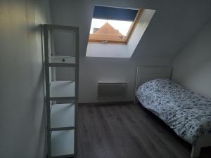 a small bedroom with a bed and a window at le cantalou in Rinxent