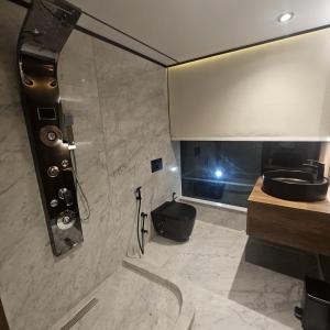 a bathroom with a shower with a sink and a mirror at Supperyacht Jack Sparrow in Hurghada