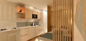a kitchen with white cabinets and a sink at Studio près de la plage in La Grande-Motte