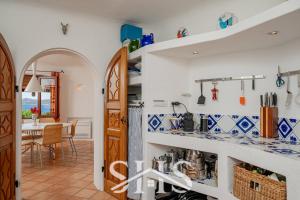 a kitchen and dining room with blue and white tiles at Villa Canapiglia - Mediterranean Soul Retreat in Porto Rafael
