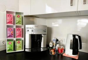 a kitchen counter with a coffee maker and a microwave at Pension Auwirt Saalbach in Saalbach-Hinterglemm +24 photos