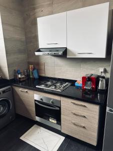 a kitchen with a stove and a stove top oven at Blue Hope Duplex with sea and mountain views in Taghazout