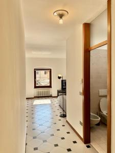 a hallway with a bathroom with a toilet and a sink at 1Dest - Riva Life in Riva del Garda +30 photos