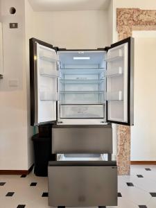 an empty refrigerator with its doors open in a room at 1Dest - Riva Life in Riva del Garda