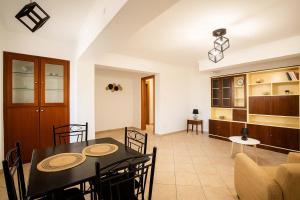 a dining room and living room with a table and chairs at Sea & Mountain Horizon by Myrto in Diakopto