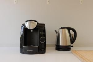 a toaster and a coffee pot sitting on a counter at 2-Bed Flat with Free Parking by Lee Valley Park in Enfield