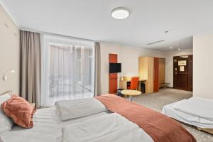 Postel nebo postele na pokoji v ubytování Hotel Schild