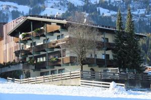 a large building in the snow with snow at Ferienwohnungen Egger in Fügen