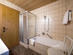 a bathroom with a bath tub and a shower at Ferienwohnungen Egger in Fügen +33 photos
