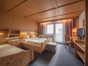 a large room with two beds and a television at Ferienwohnungen Egger in Fügen