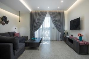 a living room with a couch and a table at Matsi Suites in Faliraki